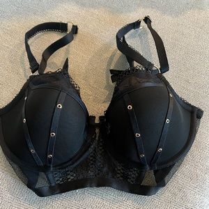 Honey Birdette black bra with gold grommets and sheer material.